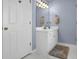 Bathroom vanity area featuring white cabinets, brushed gold hardware, and a framed mirror at 361 Fountainmist Trl, Lawrenceville, GA 30043