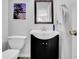 Bathroom with a black vanity and white countertop, toilet and coastal themed artwork at 361 Fountainmist Trl, Lawrenceville, GA 30043