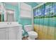 Bathroom featuring a vanity with white cabinetry and a toilet with an ocean themed shower curtain at 361 Fountainmist Trl, Lawrenceville, GA 30043