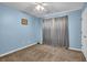 A bedroom painted in a light blue with carpeted floors and a ceiling fan at 361 Fountainmist Trl, Lawrenceville, GA 30043