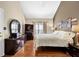 Bedroom featuring hardwood floors, a bed and dresser with a mirror at 361 Fountainmist Trl, Lawrenceville, GA 30043