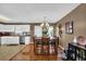 Bright dining area features a wooden table, a modern chandelier, and stylish decor at 361 Fountainmist Trl, Lawrenceville, GA 30043