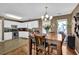 Charming dining area features hardwood floors, a wooden table, and access to the kitchen at 361 Fountainmist Trl, Lawrenceville, GA 30043