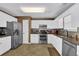 A kitchen featuring white cabinetry, stainless steel appliances and granite countertops at 361 Fountainmist Trl, Lawrenceville, GA 30043