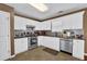 Galley kitchen featuring white cabinetry, stainless steel appliances, and granite countertops at 361 Fountainmist Trl, Lawrenceville, GA 30043