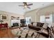 Bright living room features hardwood floors, a fireplace, and a comfortable leather sectional at 361 Fountainmist Trl, Lawrenceville, GA 30043