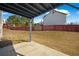 Covered back patio with concrete pad and a view of the large, fenced backyard at 6279 Nellie Se Br, Mableton, GA 30126