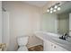 Well-lit bathroom features a toilet, vanity, sink, and tiled shower at 6279 Nellie Se Br, Mableton, GA 30126