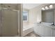 Bathroom featuring dual sinks, a soaking tub, and a separate shower with glass doors at 6279 Nellie Se Br, Mableton, GA 30126