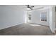 Large bedroom featuring neutral carpet, white trim, and abundant natural light from two windows at 6279 Nellie Se Br, Mableton, GA 30126