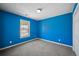 A bedroom featuring light-blue walls, plush carpet, and a bright window offering natural light at 6279 Nellie Se Br, Mableton, GA 30126