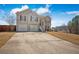 Inviting two-story home with an attached two-car garage, complemented by a well-maintained lawn at 6279 Nellie Se Br, Mableton, GA 30126