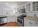 Kitchen with stainless steel appliances, granite countertops, and white cabinets at 6279 Nellie Se Br, Mableton, GA 30126