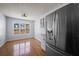 View of kitchen nook, featuring stainless steel refrigerator, hardwood floors, and a bright window at 6279 Nellie Se Br, Mableton, GA 30126