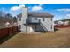 View of the back of the home with light gray siding, a small upper deck, and a fenced-in yard at 6279 Nellie Se Br, Mableton, GA 30126