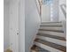 Carpeted stairway leading to the upper level, with white railing and natural light at 6279 Nellie Se Br, Mableton, GA 30126