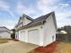 Two-story home with white siding and a two-car garage, showcasing curb appeal at 3745 Talbot Nw Ln, Acworth, GA 30101