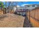 View of the backyard with a wooden fence, deck, and partial view of the home at 5043 Bell Dr, Smyrna, GA 30080