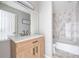 Renovated bathroom with a new vanity and a bathtub with marble tiling at 5043 Bell Dr, Smyrna, GA 30080