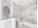 Well lit bathroom featuring a tub and shower combination and white marble tiling at 5043 Bell Dr, Smyrna, GA 30080