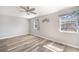 A bedroom showcasing the new wood floors, ceiling fan, and natural light from windows with decorative curtains at 5043 Bell Dr, Smyrna, GA 30080