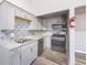 Updated kitchen with stainless steel appliances and granite countertops, mosaic backsplash, and gray cabinetry at 5043 Bell Dr, Smyrna, GA 30080