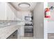 A functional kitchen with stainless steel oven and mosaic backsplash, providing ample storage at 5043 Bell Dr, Smyrna, GA 30080