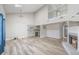 Spacious living room with a fireplace, wood floors, and an adjacent kitchen area at 5043 Bell Dr, Smyrna, GA 30080