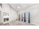Bright living room with a fireplace and large windows, showcasing modern flooring and vaulted ceiling at 5043 Bell Dr, Smyrna, GA 30080