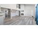 Open-concept living space with a fireplace, wood floors, and an updated kitchen at 5043 Bell Dr, Smyrna, GA 30080