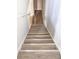 Stairway features a wooden railing with bright, neutral colored walls and laminate plank flooring at 5043 Bell Dr, Smyrna, GA 30080