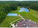 Aerial view of a sports court and a pond in the backyard of a home at 535 Waters Way, Fayetteville, GA 30215