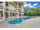 Multi-level backyard with a beautiful pool, covered patios and lush trees at 535 Waters Way, Fayetteville, GA 30215