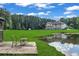 Scenic backyard with a pond and lush green lawn, perfect for outdoor relaxation at 535 Waters Way, Fayetteville, GA 30215