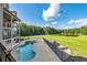 Beautiful backyard with a pool, lush greenery, and views of the lake at 535 Waters Way, Fayetteville, GA 30215