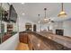 Wet bar featuring granite countertops, a mirrored backsplash, and pendant lighting at 535 Waters Way, Fayetteville, GA 30215