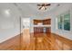 Wet bar area with wood cabinets, granite countertop, mini-fridge and access to another room at 535 Waters Way, Fayetteville, GA 30215