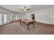 Finished basement with a pool table, neutral carpet, and walkout access to the outdoors at 535 Waters Way, Fayetteville, GA 30215