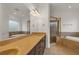 Spacious bathroom with a double vanity, soaking tub, and glass enclosed shower at 535 Waters Way, Fayetteville, GA 30215