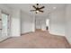 Bedroom with a ceiling fan, neutral carpet, and balcony access at 535 Waters Way, Fayetteville, GA 30215