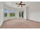Bright bedroom features a ceiling fan, two windows, and french doors to the balcony at 535 Waters Way, Fayetteville, GA 30215