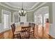 Elegant dining room with hardwood floors, chandelier, and wainscoting, perfect for formal gatherings at 535 Waters Way, Fayetteville, GA 30215
