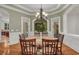 Stylish dining room with hardwood floors, traditional chandelier, and views of the surrounding greenery at 535 Waters Way, Fayetteville, GA 30215