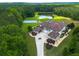 Stunning estate with manicured landscaping, private pond, and an outdoor sports court at 535 Waters Way, Fayetteville, GA 30215