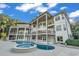Multi-story home exterior featuring a pool, hot tub, and multiple balconies at 535 Waters Way, Fayetteville, GA 30215