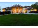 Elegant exterior of a large home with arched windows and a well-manicured lawn at 535 Waters Way, Fayetteville, GA 30215