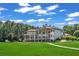 Expansive home with multiple floors, balconies, and a well-manicured lawn at 535 Waters Way, Fayetteville, GA 30215