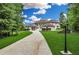 Beautiful home with a circular driveway, manicured lawn, and elegant exterior design at 535 Waters Way, Fayetteville, GA 30215