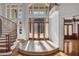 Elegant foyer with a winding staircase, marble floors, and large windows at 535 Waters Way, Fayetteville, GA 30215