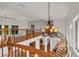 Elegant foyer with a winding staircase, wooden banisters, and a view of the chandelier and upper level at 535 Waters Way, Fayetteville, GA 30215